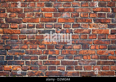 Old weathered red brick wall as background Stock Photo