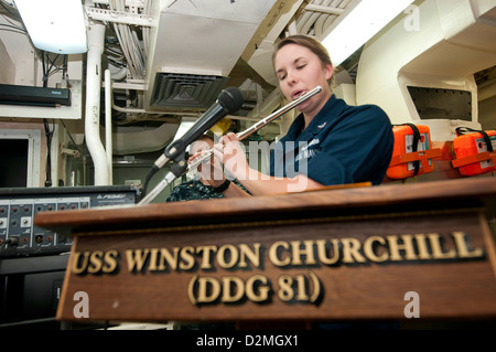 Sonar Technician (Surface) 3rd Class Caroline E. Stacy, from Bristol, Va., plays the National Anthem on the flute during a ceremony celebrating Martin Luther King Jr. Day aboard the guided-missile destroyer USS Winston S. Churchill (DDG 81). Churchill is Stock Photo
