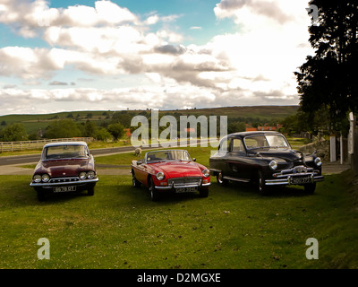 from left  Ford Consul, MG and Vanguard, classic cars parked on the common in Goathland, North Yorkshire. Stock Photo