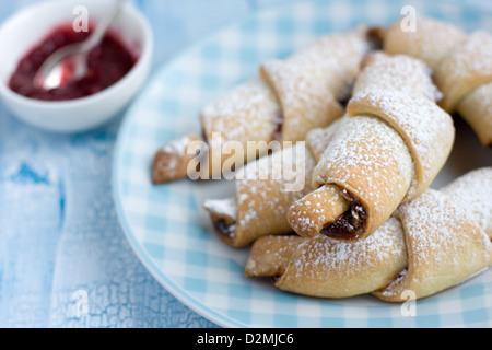 Rugelach with Raspberry jam filling on the light blue plate Stock Photo
