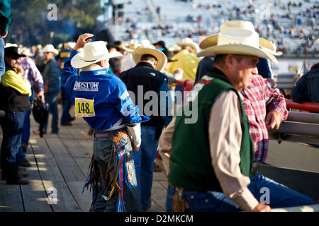 A bull rider goes through his riding motions before climbing on board the bul atthe Salinas Rodeo Stock Photo