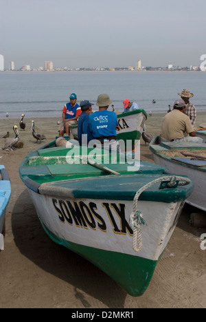 Commercial fishing boats, (Pangas) on the beach at Mazatlan,Mexico where fishermen prepare their night's catch for marketing. Stock Photo