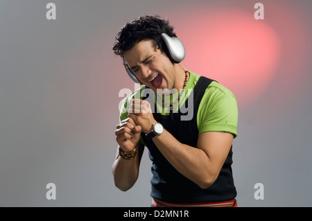 Man listening to music and looking excited Stock Photo