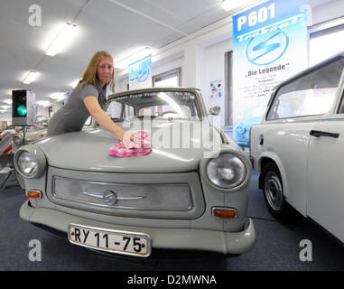 Kristina Suranyi frees a grey Trabant from dust at the GDR Museum 'Zeitreise' (Time Travel) in Radebeul, Germany, 07 October 2009. The Trabant is a product of the automobile industry of the GDR, the former German Democratic Republic. More than 38.000 exhibits of the everyday life in the former socialist state can be seen at the museum. Around 50.000 guests visits the exhibition each year. Photo: Ralf Hirschberger Stock Photo