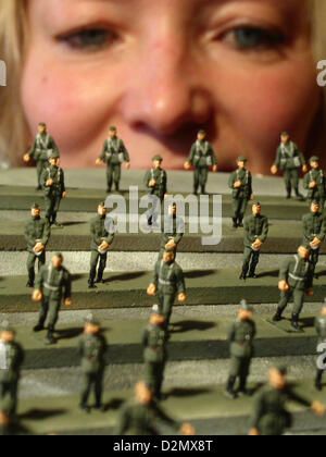 Tin figure painter Angelika Hauser looks at miniature NVA soldiers (National People's Army of the GDR) of the scale 1:87 at the scale model company Ritter C.B. von Krauthauser in Waltersdorf, Germany, 17 January 2005. The miniature models are around the size of a two-cents-coin. The company specialized on models of the First and Second World War, as well was GDR vehicles. The ideas come from what one can find on decaying industrial sites, museums and old photographs. There are around 200 dealers and 100 collectors in Germany, Austria, Switzerland and the US ordering the products of the company Stock Photo