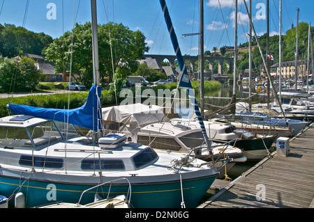 Sailboats moored on River Rance, with viaduct in the background, Dinan harbour, Brittany, France, Europe Stock Photo