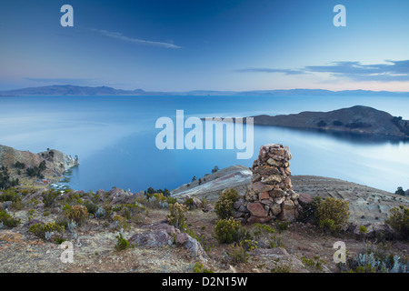 Stack of prayer stones on Isla del Sol (Island of the Sun) at sunset, Lake Titicaca, Bolivia, South America Stock Photo