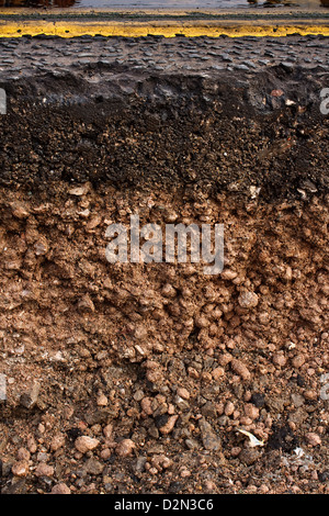 Cut away cross section of a street with exposed soil underneath while maintenance work for utilities company is in progress Stock Photo