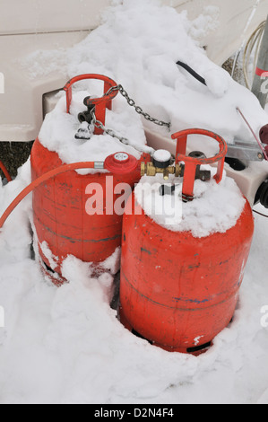 Caravan in an all season caravan park photographed during january's snow fall, Propane gas -bottle used use during colder months Stock Photo