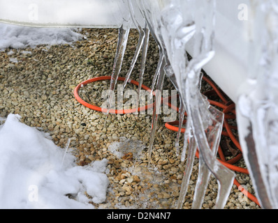 Icicles formed on the bottom of a caravan in an all season caravan park photographed during a freeze-up in January, Henley-on-Thames, Oxfordshire, UK Stock Photo