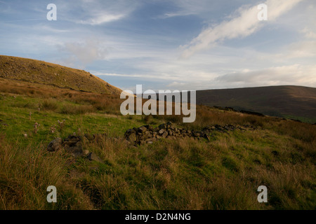 Views over Saddleworth in the Pennines showing grazing field patterns and weavers cottages and moorland on the tops Stock Photo