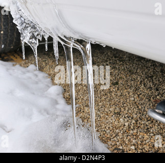Icicles formed on the bottom of a caravan in an all season caravan park photographed during a freeze-up in January, Henley-on-Thames, Oxfordshire, UK Stock Photo