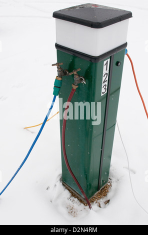 Electric console for supplying 240 volt supply to caravans in an all season caravan park photographed after January snowfall Henley-on-Thames, Oxon,UK Stock Photo