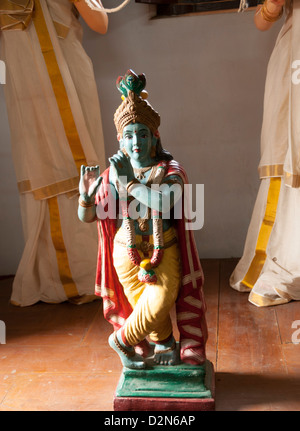 Deity  of Krishna playing flute Stock Photo