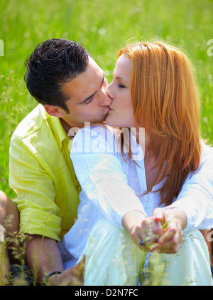 Young couple in their 20s kissing outdoor in summer. Stock Photo
