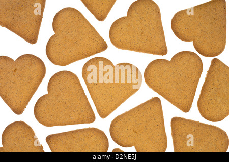 Several heart shaped ginger snap cookies on a white background. Stock Photo