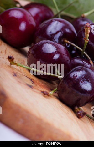 photo of sweet cherries on a wooden board Stock Photo