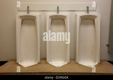 full length urinals in mens toilet of High school canada north america Stock Photo