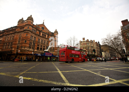 A traditional double decker bus, passes in front of one of London's playhouses Stock Photo