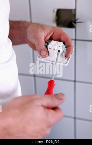 Electrician connecting plug Stock Photo