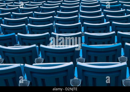 Seating rows in a stadium with weathered chairs Stock Photo