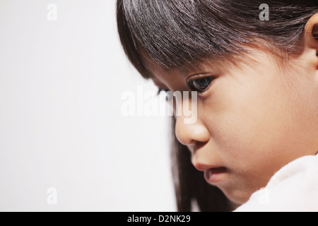 Close up of a sad girl looking down Stock Photo
