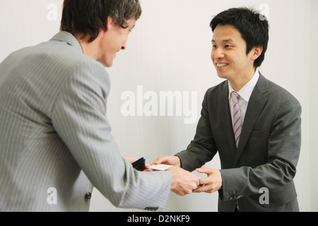 Businessmen exchanging business cards in the office Stock Photo