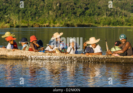 Malagasy people of ethnic Betsimisaraka crossing the river by canoe on apr 22, 2007 near Maroantsetra in eastern Madagascar Stock Photo