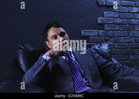 Businessman sitting on a sofa Stock Photo