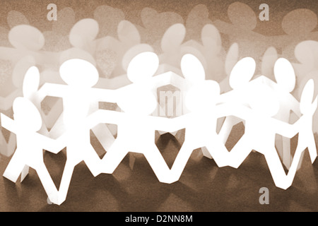 Crowd of Paper Chain People on Brown Background Stock Photo