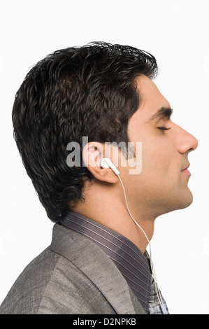 Businessman listening to music Stock Photo