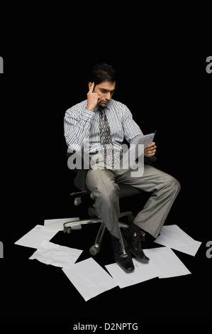 Businessman reading a document Stock Photo