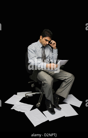 Businessman reading a document Stock Photo
