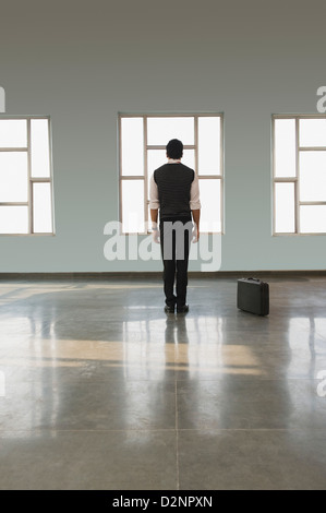 Businessman standing in an empty office Stock Photo