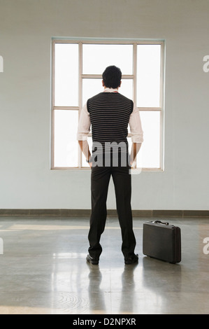 Businessman standing in an empty office Stock Photo