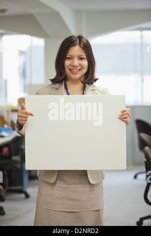 Businesswoman holding a white board Stock Photo