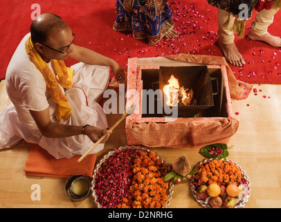 Priest performing religious ceremony in wedding mandap Stock Photo