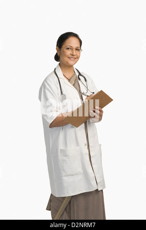 Female doctor holding a clipboard and smiling Stock Photo