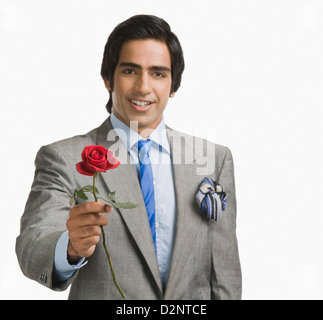 Portrait of a businessman offering a red rose Stock Photo