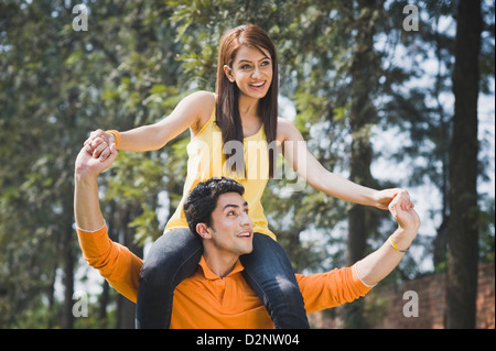 Man carrying a woman on his shoulders Stock Photo