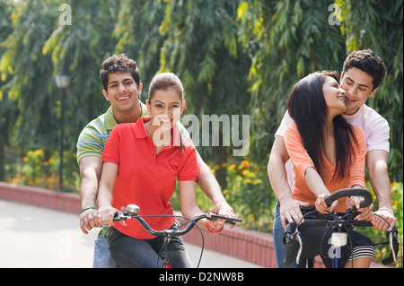 Two couples riding bicycles Stock Photo
