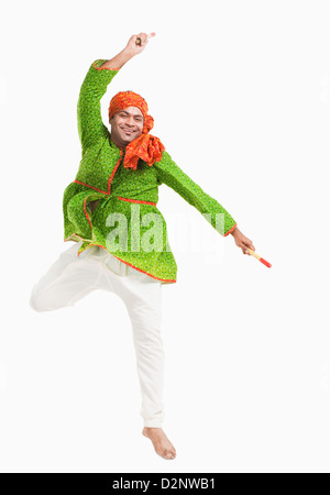 Man performing dandiya Stock Photo - Alamy