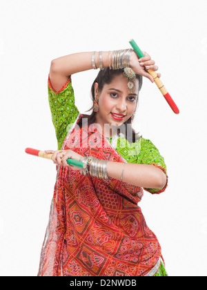 Portrait of a woman performing dandiya Stock Photo - Alamy