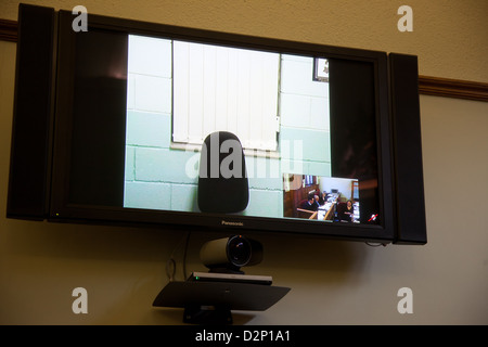 Video link up technology in a court room. Stock Photo