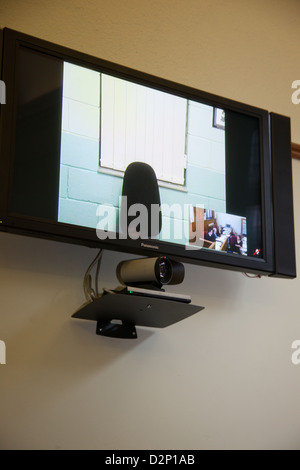 Video link up technology in a court room. Stock Photo