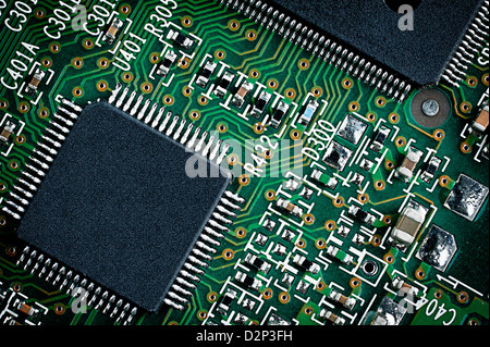 Microchip on green printed circuit board pcb. Close up macro detail. Stock Photo