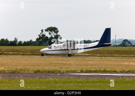Britten-Norman BN2A Islander G-AWNT taxiing along runway at Wickenby Airfield Stock Photo