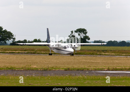 Britten-Norman BN2A Islander G-AWNT taxiing along runway at Wickenby Airfield Stock Photo