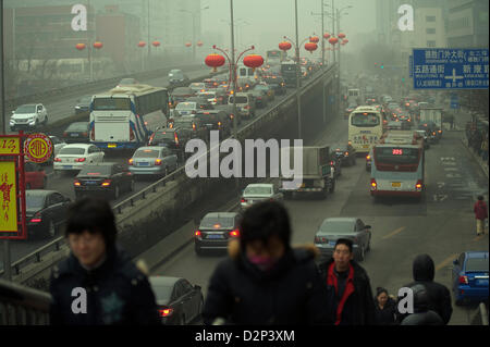 Pedestrians past heavy traffic in thick haze in Beijing,  China. 30-Jan-2013 Stock Photo