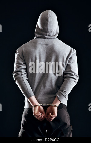 Criminal in handcuffs arrested for his crimes Stock Photo